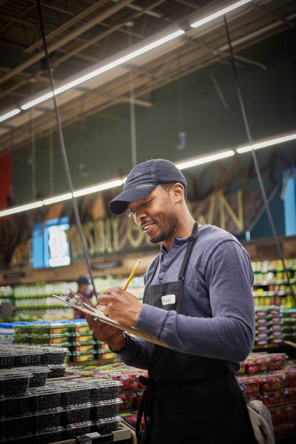 A man is writing inside a market