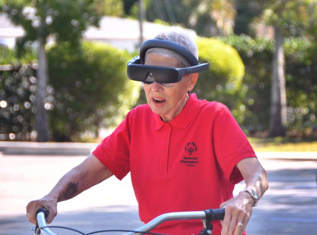Sandra-Lynn rides her bicycle while wearing her eSight 4.
