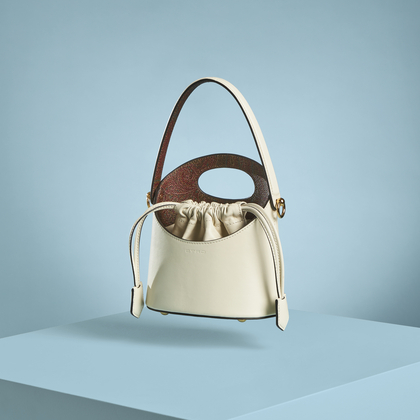 Etro beige Saturno bag in a light blue background