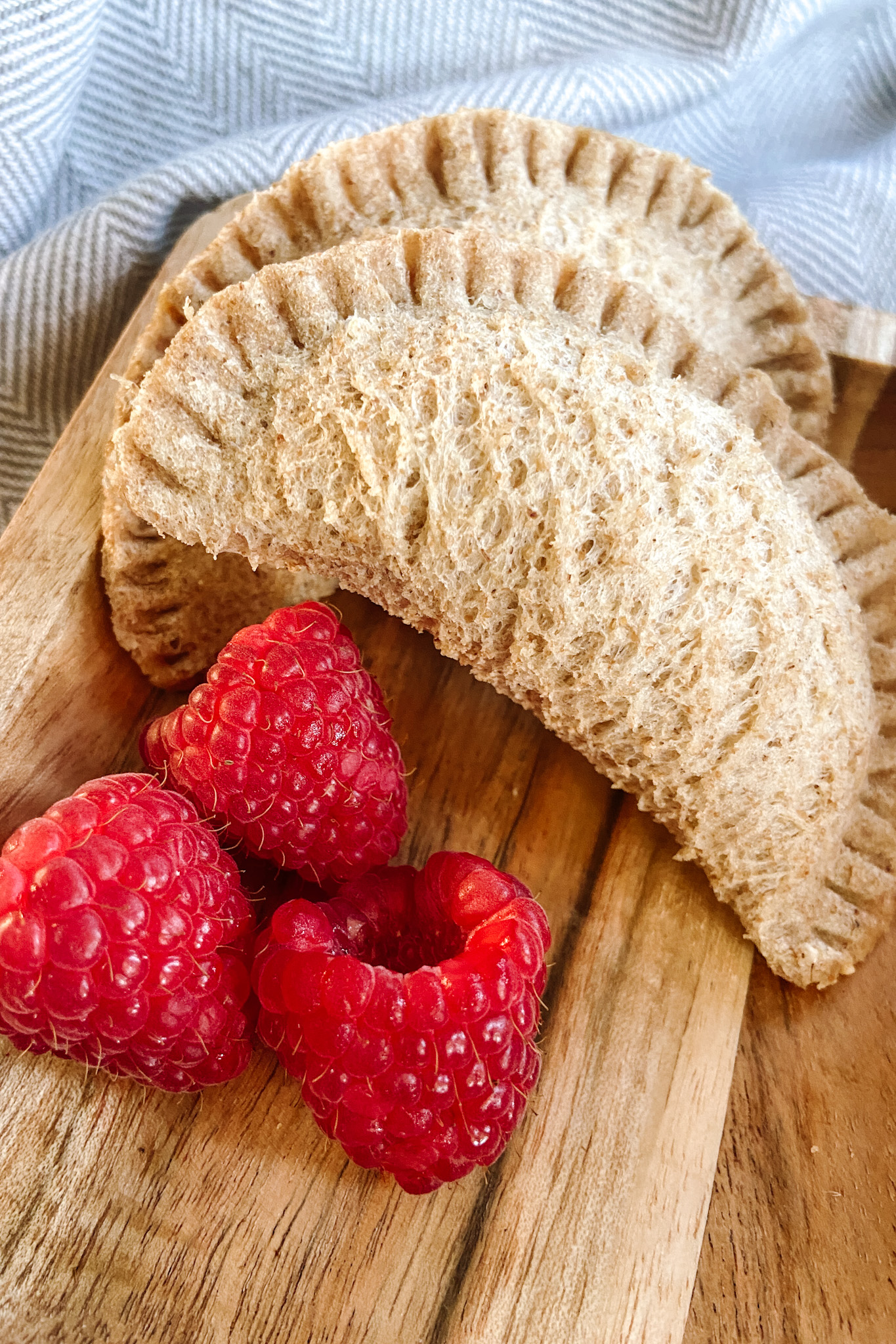 Peanut butter and empanada sandwiches served with raspberries