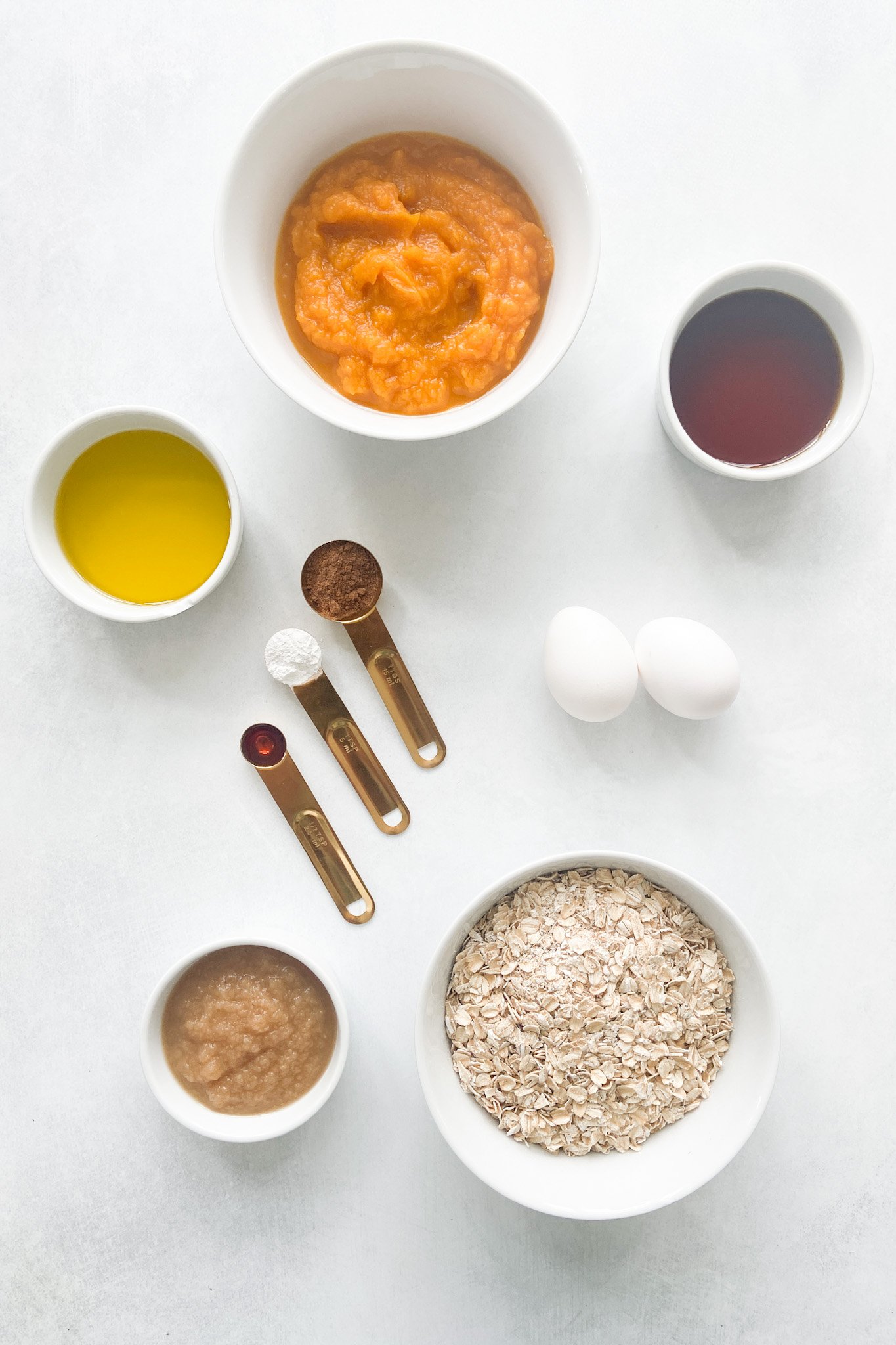 Ingredients to make pumpkin muffins. See recipe card for detailed ingredient quantities.