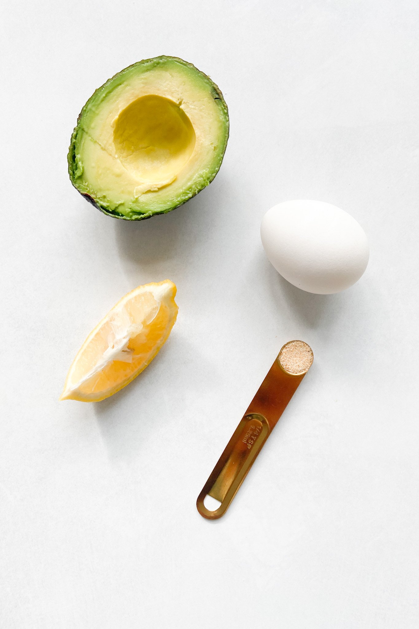 Ingredients to make avocado egg salad. See recipe card for detailed ingredient quantities.