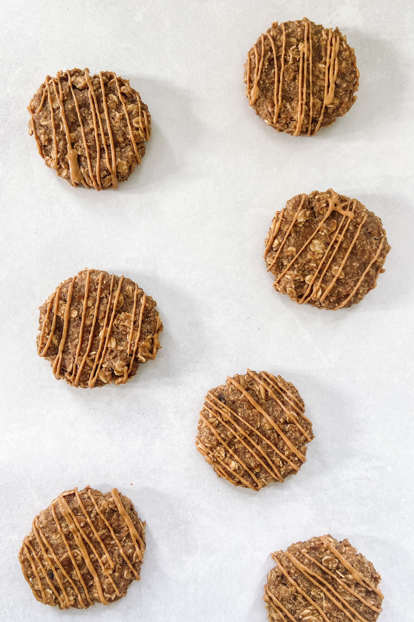 Peanut butter cookies with a drizzle of peanut butter on top