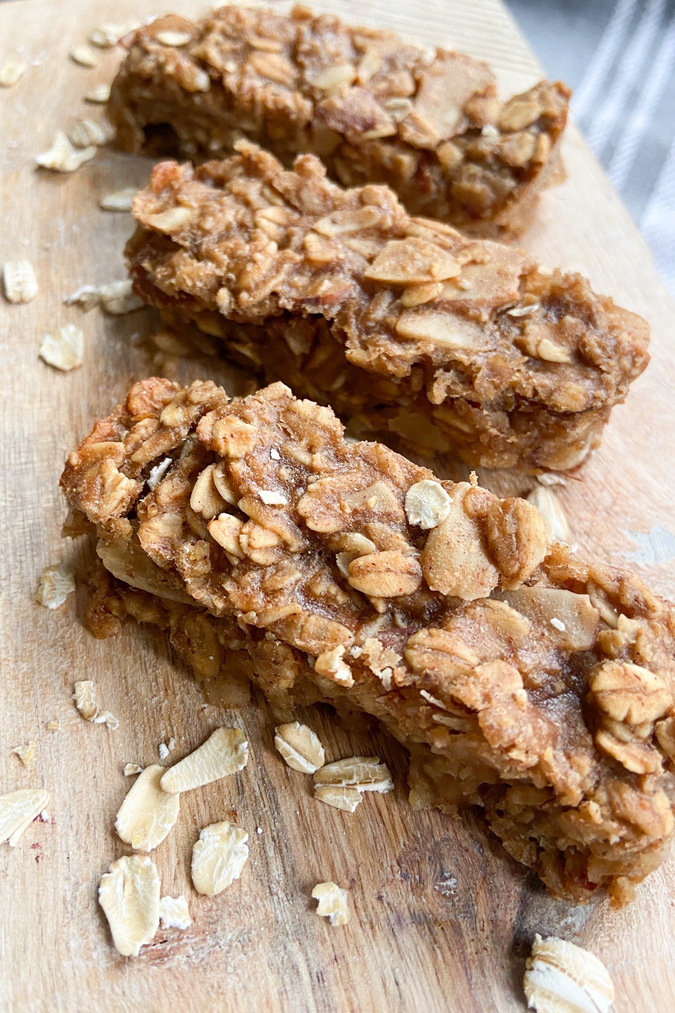 Peanut butter and banana granola bars served on a wooden cutting board