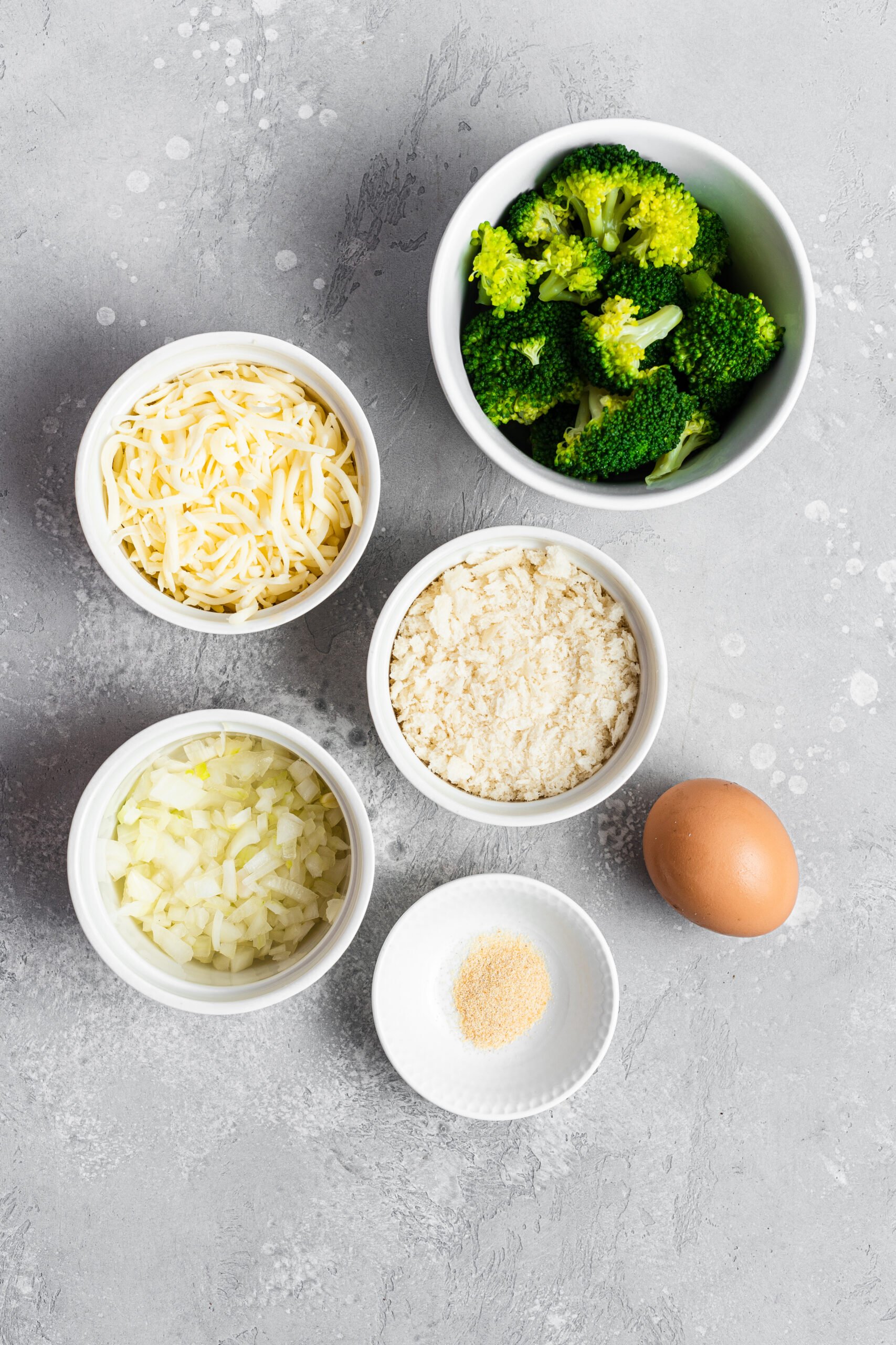 Ingredients to make broccoli and cheese bites. Specifics provided in recipe card.