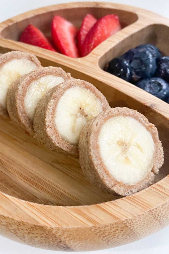 Peanut butter and banana rollups served with strawberries and blueberries