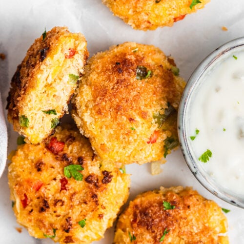 Salmon cakes served with a side of yogurt dip