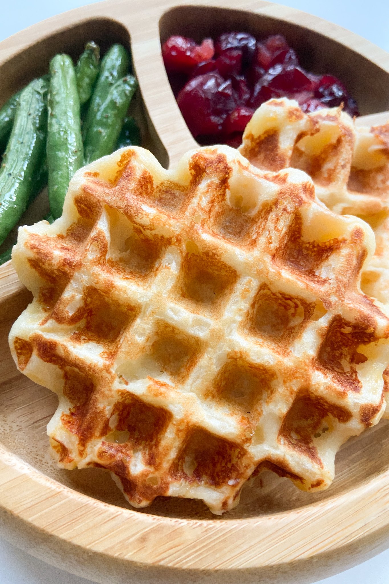 Mashed potato waffles served with green beans and mashed potatoes.