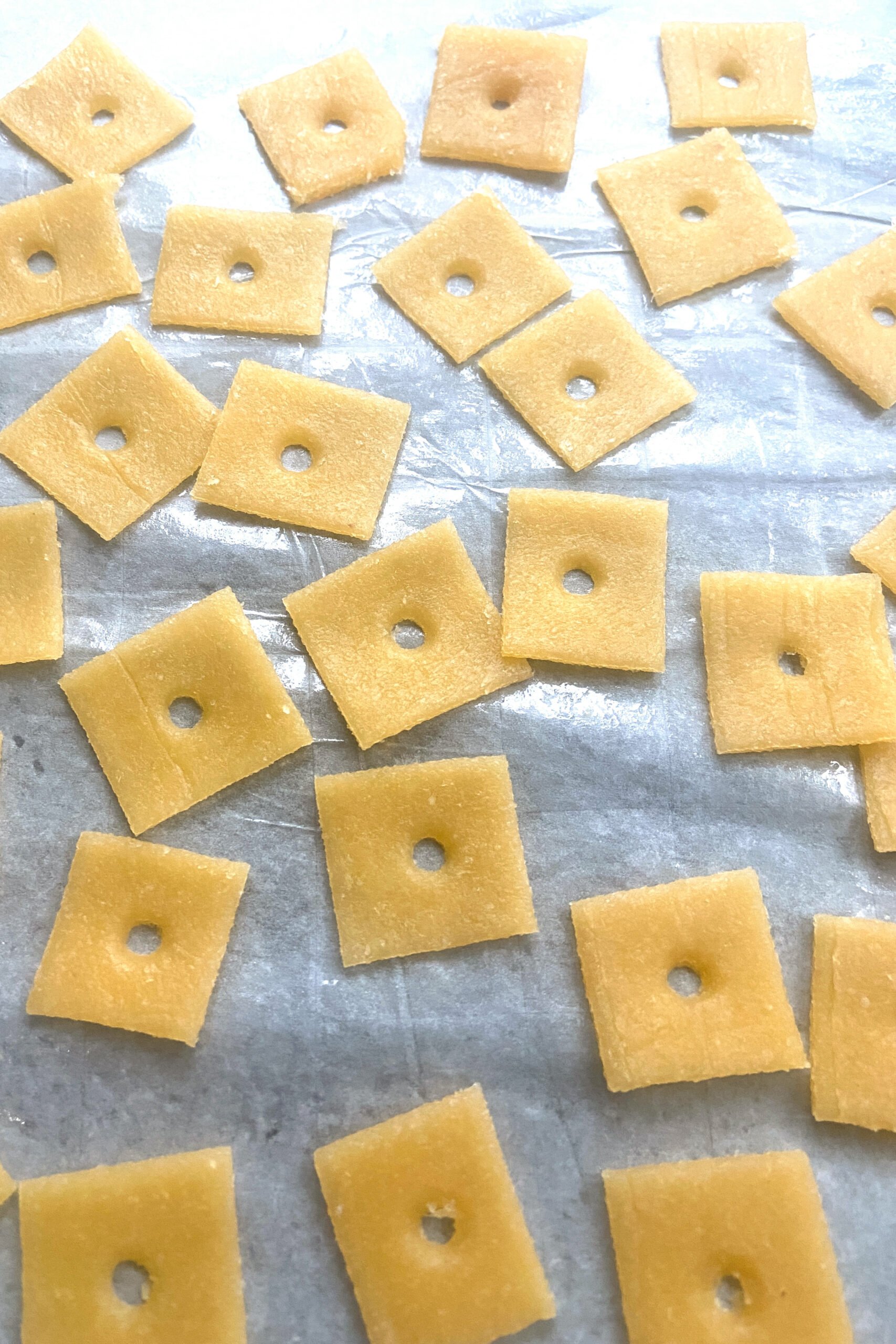 Homemade cheez-it crackers ready to go into the oven