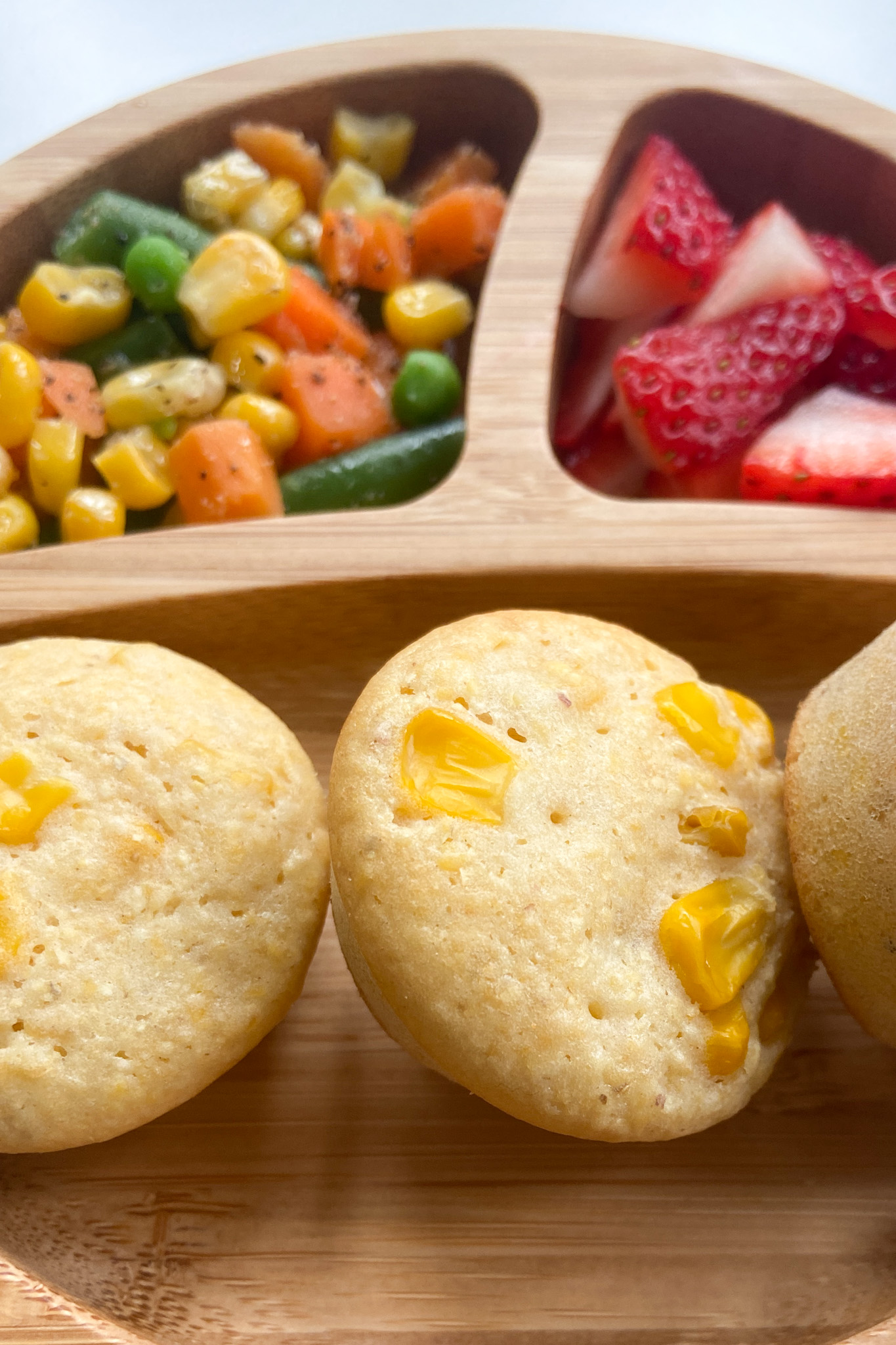 Double corn muffins served with veggies and strawberries