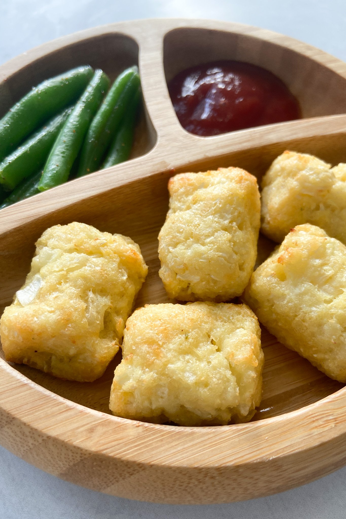 Cauliflower tots served with ketchup and green beans