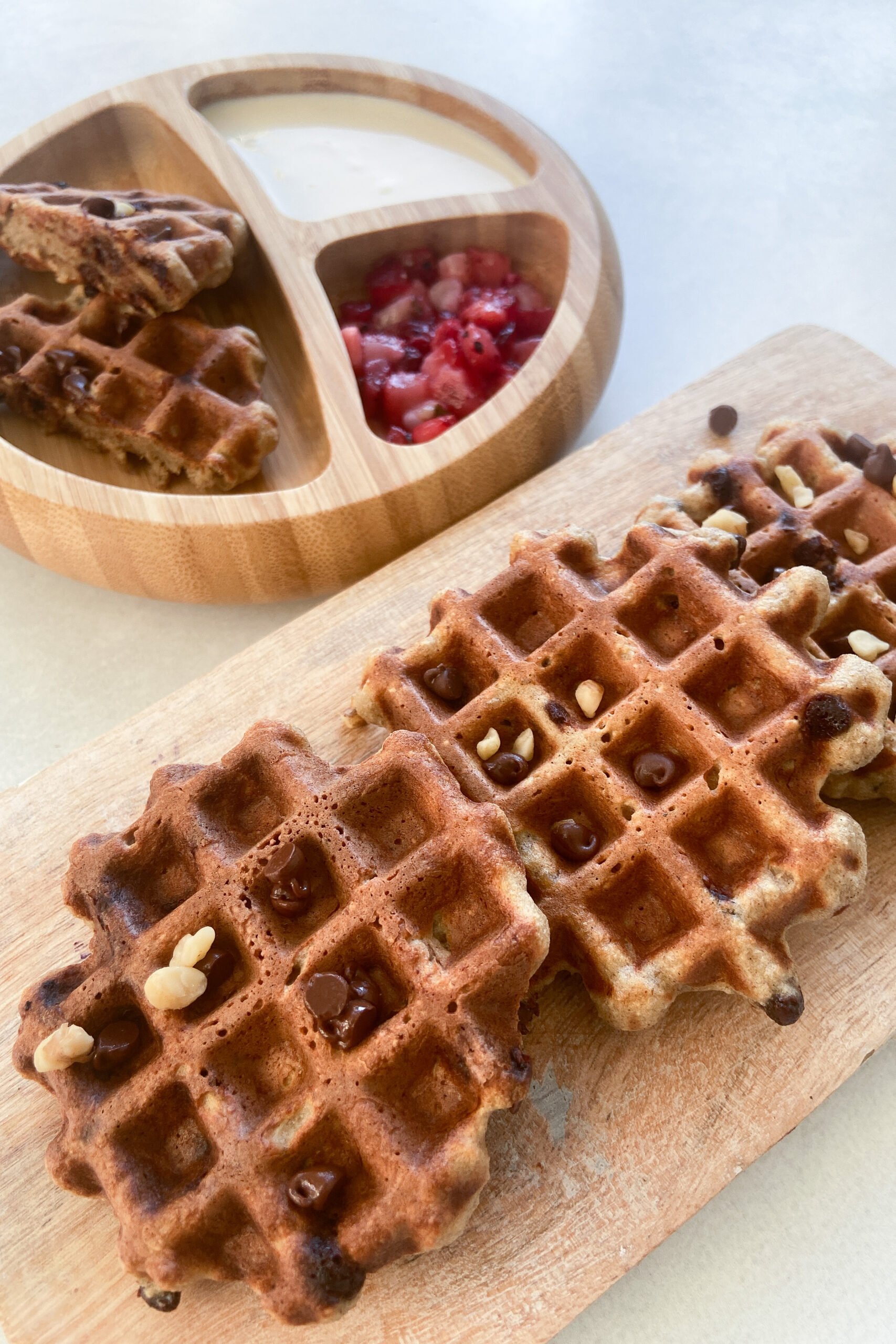 Banana oat waffles topped with chocolate chips and nuts