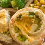 Broccoli and cheese pinwheels served with broccoli and roasted corn..