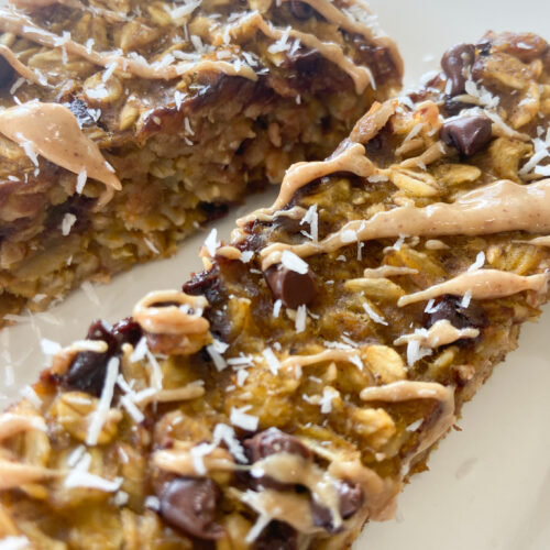 Pumpkin oat bars topped with shredded coconut.