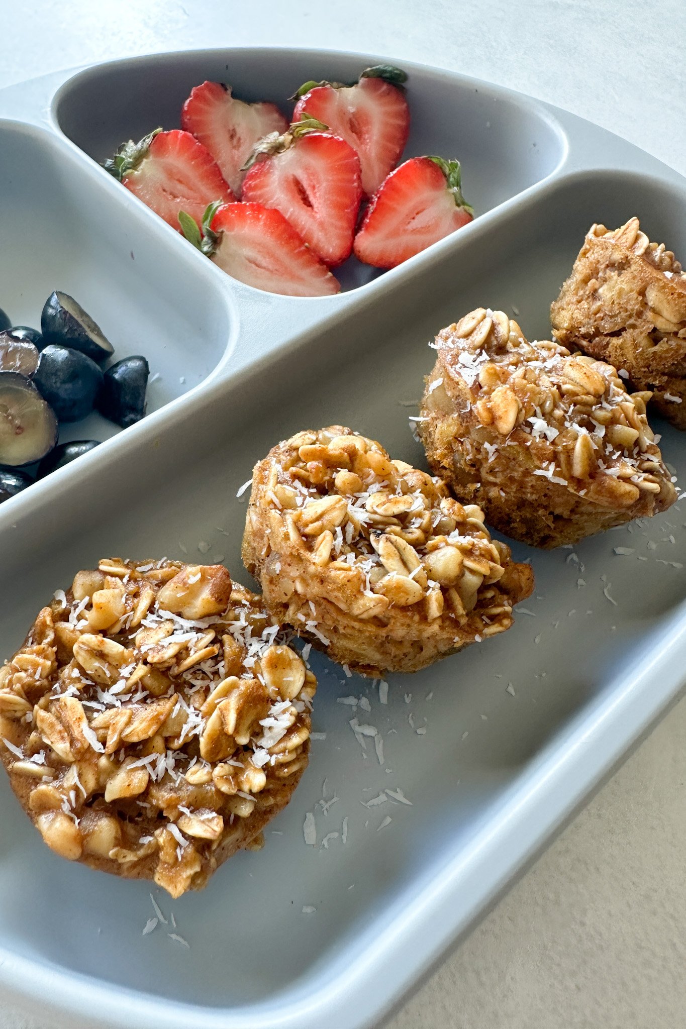 Pumpkin apple oatmeal muffins served with berries.