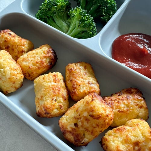 Air fryer cauliflower tots served with broccoli and ketchup.