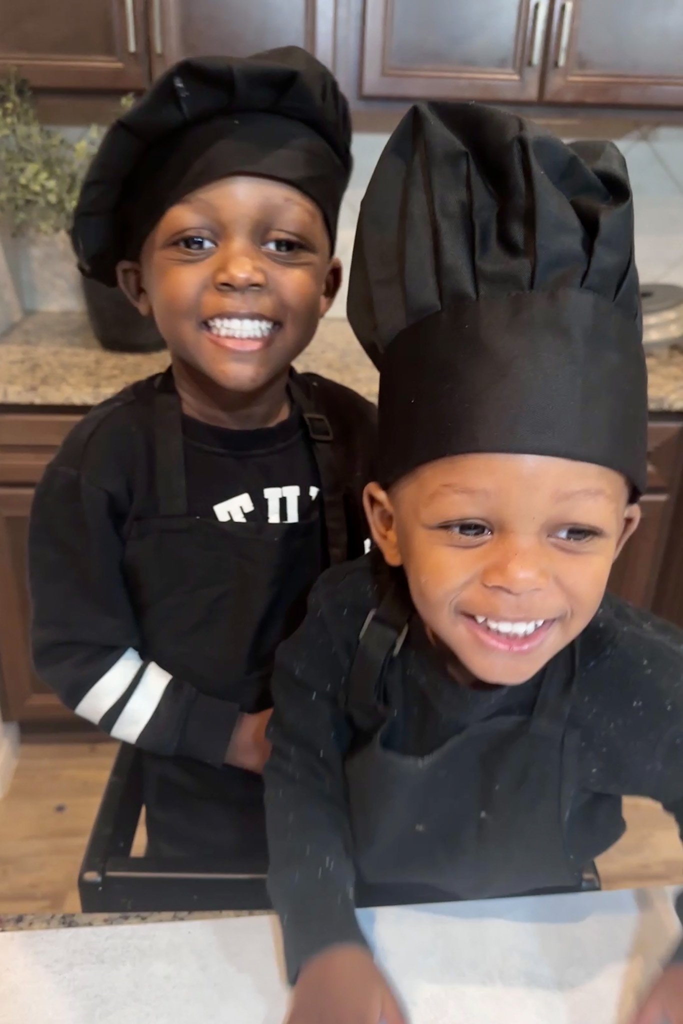 Toddler boys wearing chef hats.