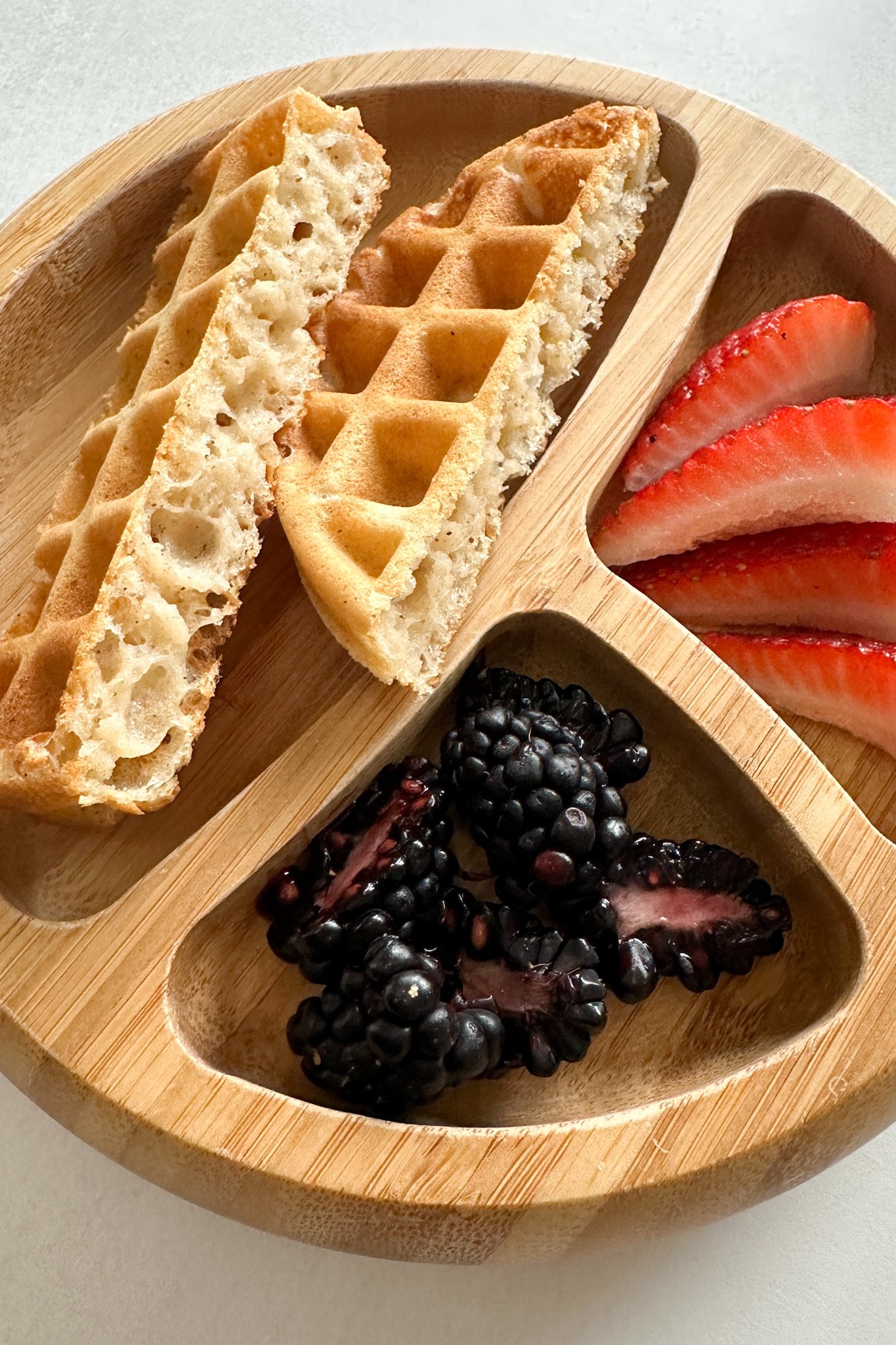 Egg free waffles served with strawberries and blackberries.