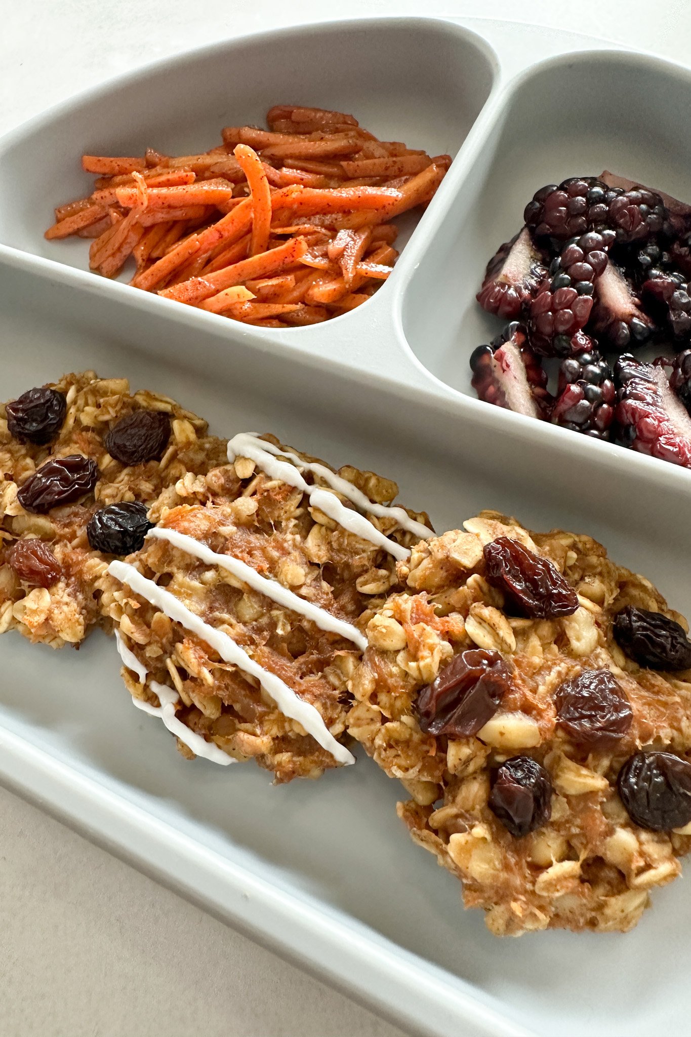 Carrot cake oatmeal cookies served with sauteed cinnamon carrots and blackberries.
