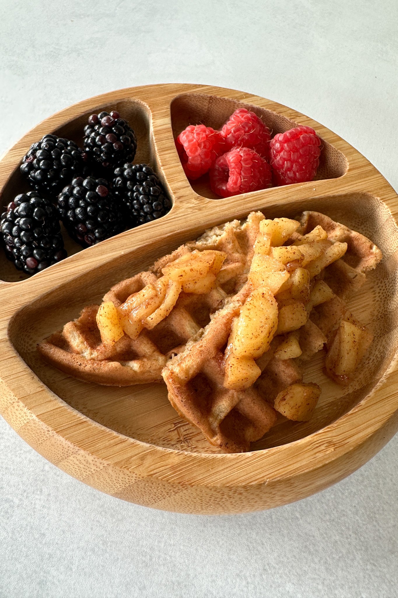 Cinnamon apple waffles topped with cinnamon apples.
