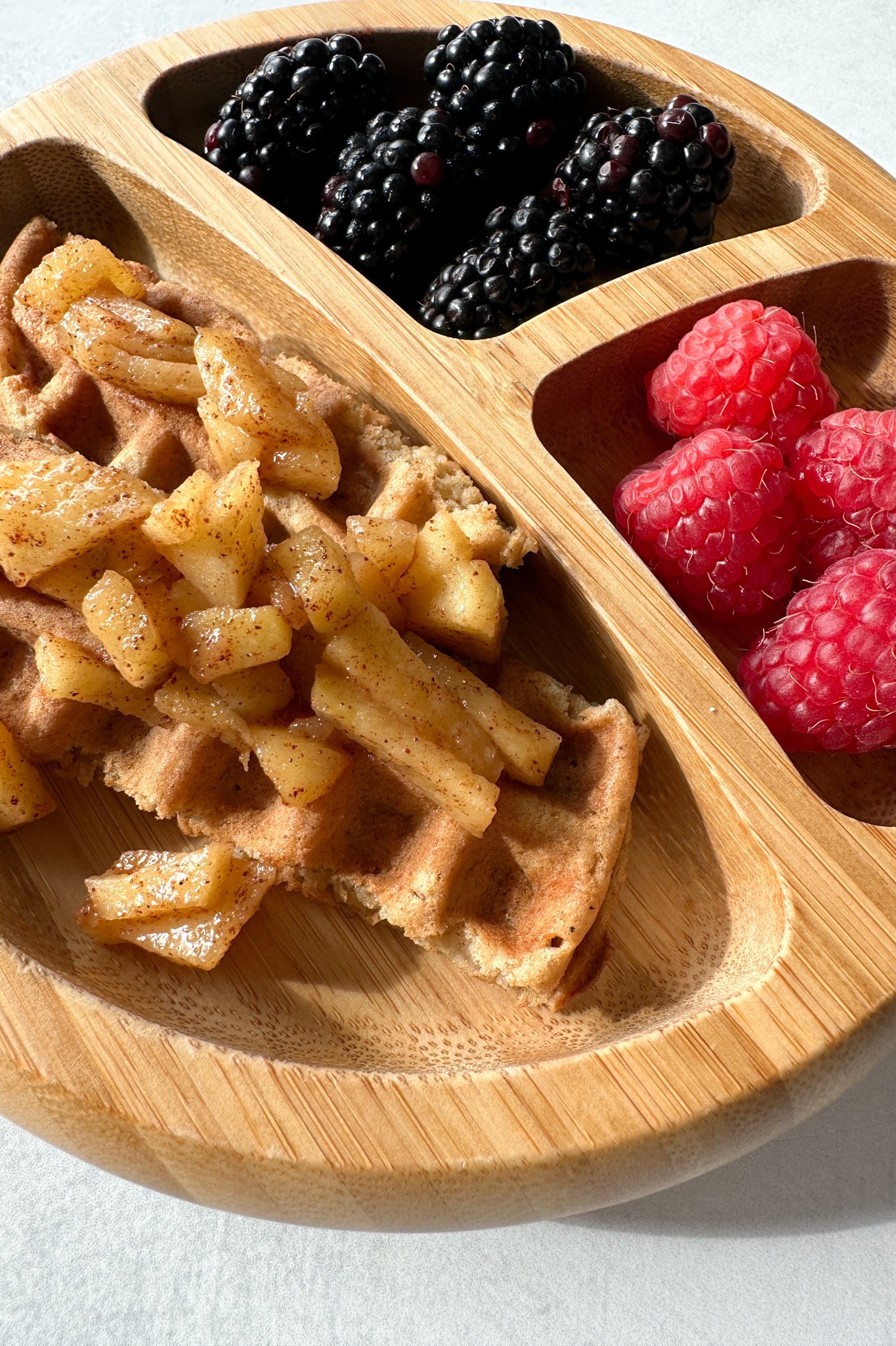 Cinnamon apple waffles topped with cinnamon apples.