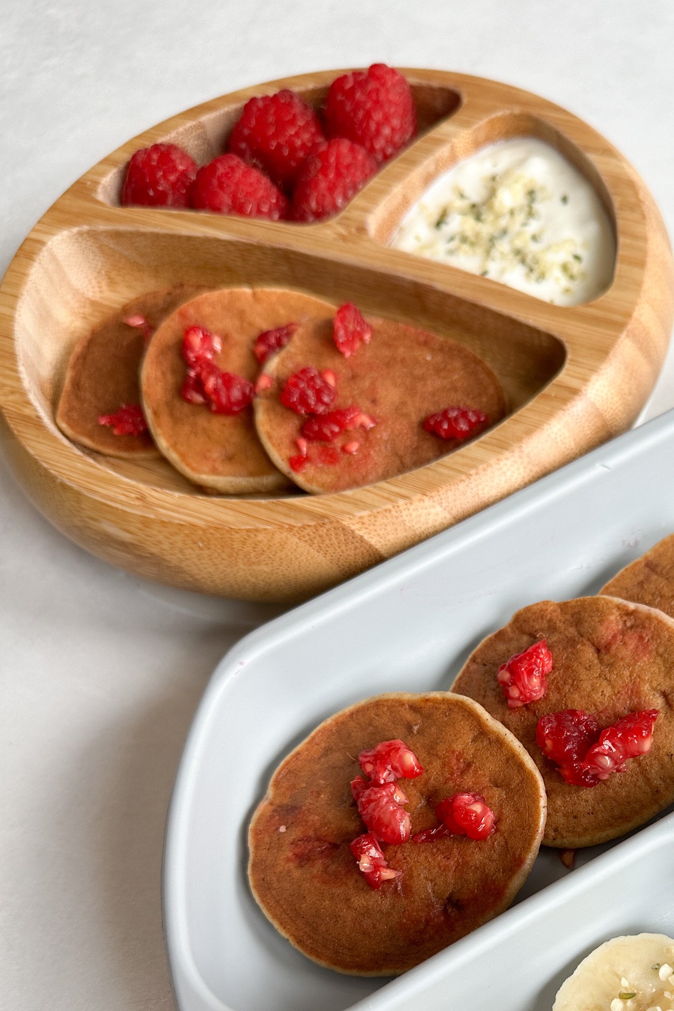 Peanut butter banana pancakes served with raspberries and bananas.