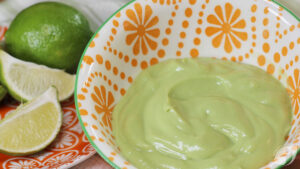 Dairy-Free Avocado Cream closeup with limes in the background