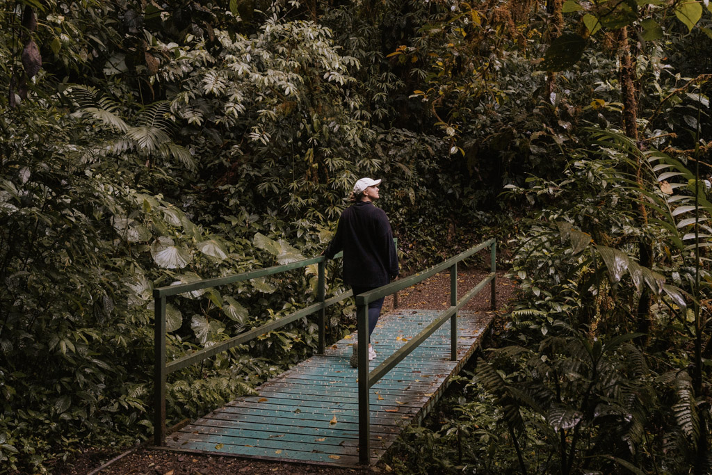 woman on blue bridge in Monteverde Cloud Forest Biological reserve