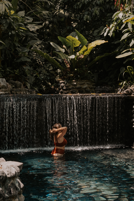 girl in lagoon at eco termales la fortuna hot spring