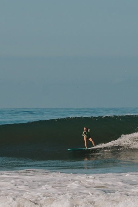 girl taking a wave at Playa Carmen a top Santa Teresa Costa Rica surf spot
