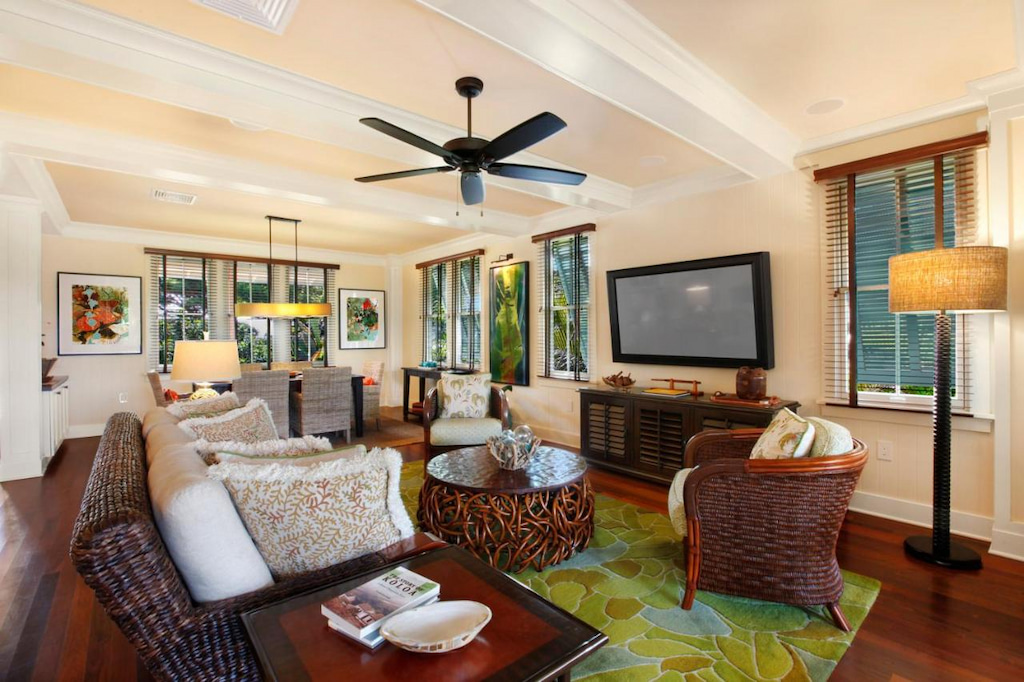 comfortable Kauai lodge with dark brown wood and rattan furniture and ceiling fan