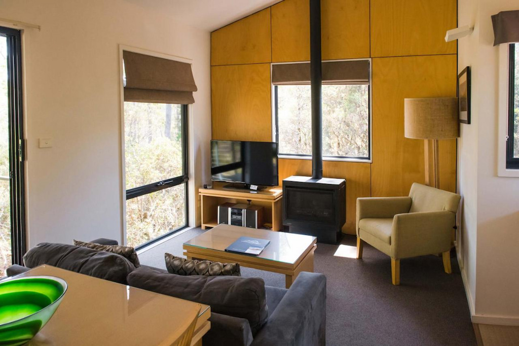 open living room with fireplace at this accommodation in Cradle Mountain