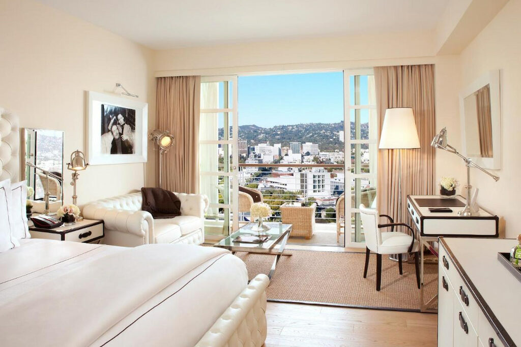 white furniture in best boutique hotel in Beverly Hills with open balcony door and views