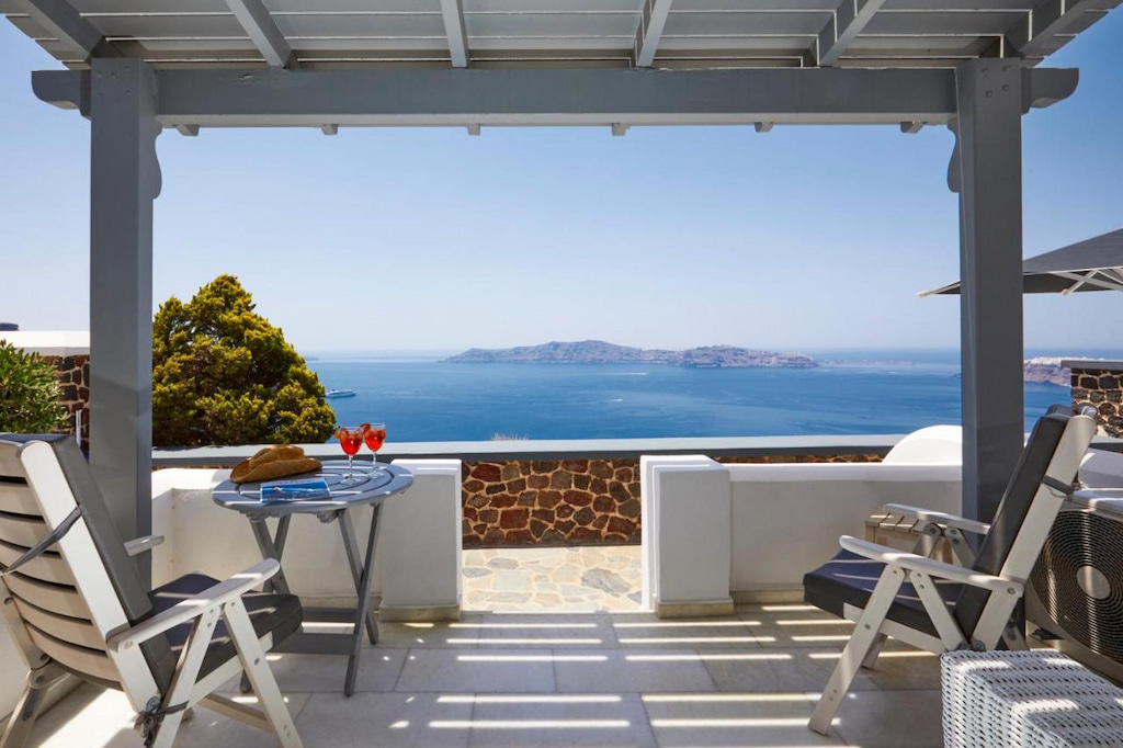 View from one of the best hotels in Santorini for honeymoon with the view of an island and the blue seas