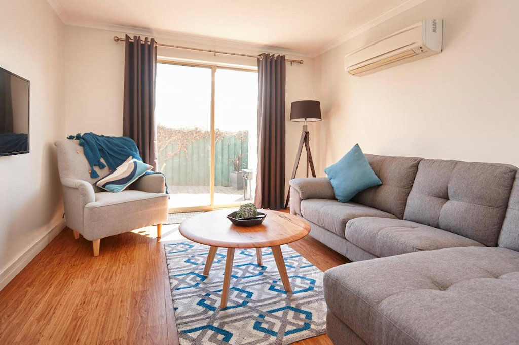 self-contained apartment in Launceston CBD with grey couch and patterned carpet