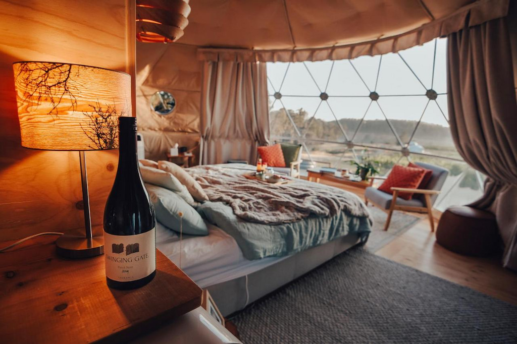 unique Tamar Valley winery accommodation with dome shaped room, cozy bed and picture window