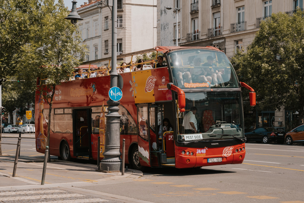red hop on hop off bus in Budapest streets