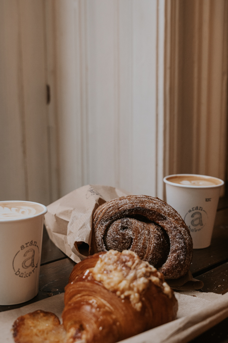 bakery items with coffee cups that are close to the coolest hotels in Budapest