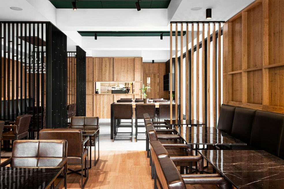A sophisticated restaurant filled with brown chairs and tables