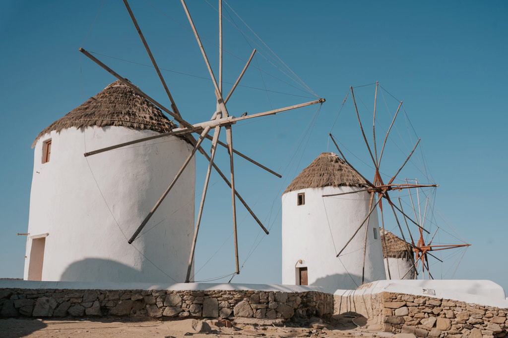 View of the windmills in Mykonos under the blue sky