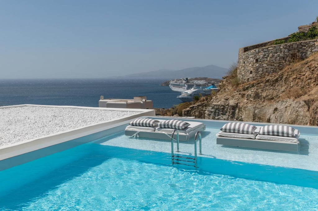 An outdoor pool with a view of the sea in Mykonos