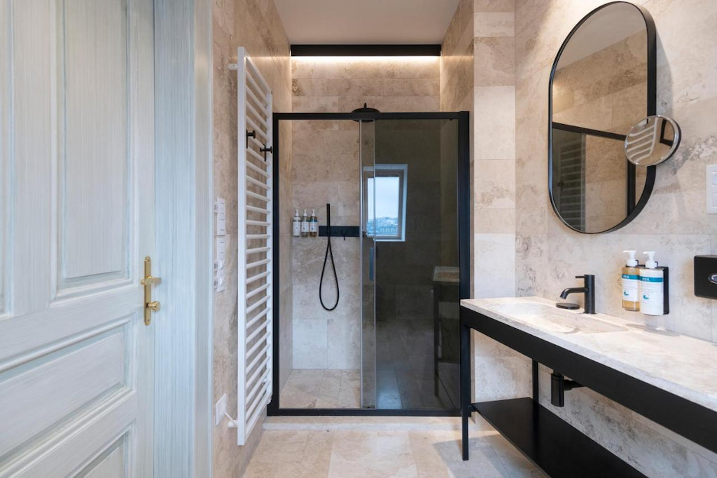 A luxury bathroom with a sliding door on the shower area