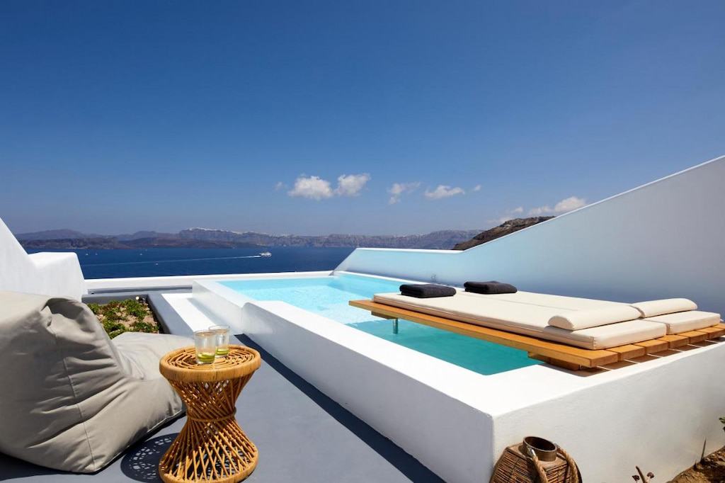 Perfect view of the Aegean Sea with a private pool with a floating deck above it - one of the best hotels in Santorini with private pools