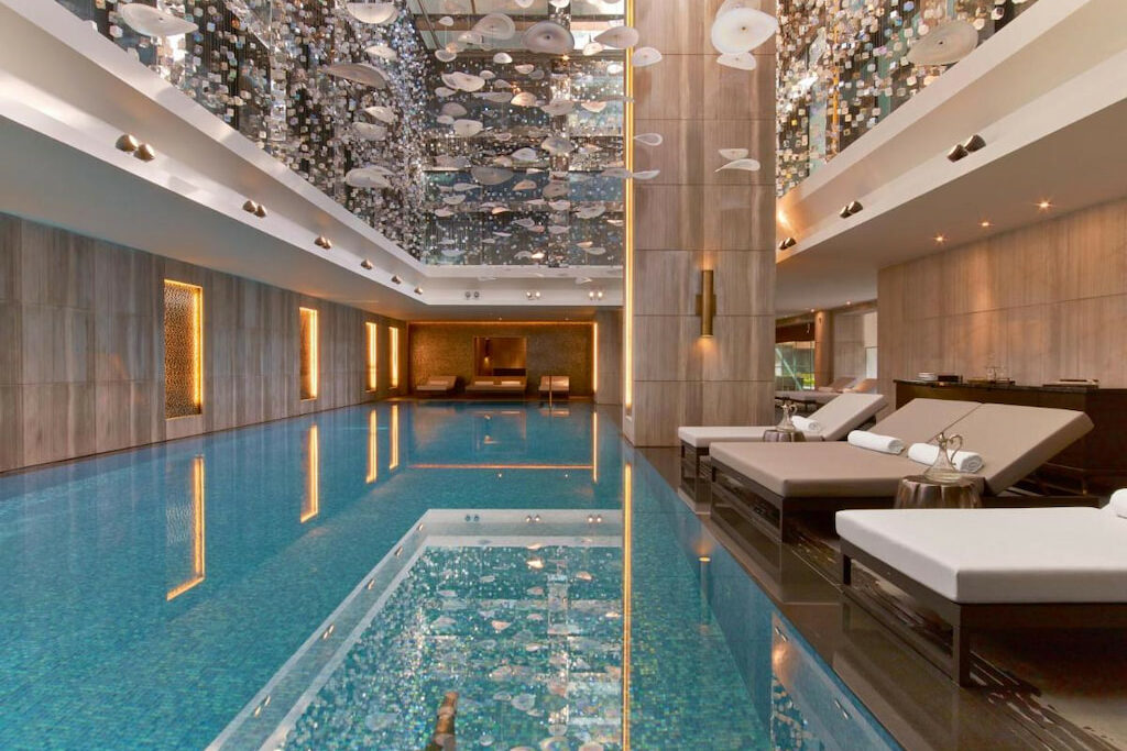 An indoor pool with amazing decoration near the benches