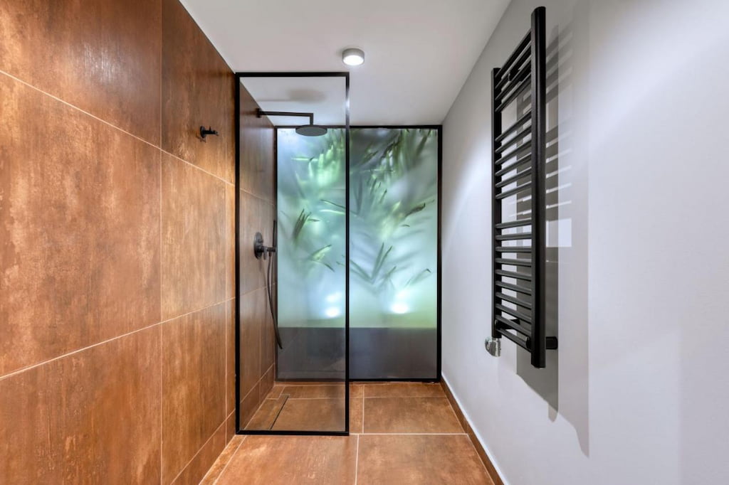 View of the minimalist shower room with brown walls and floor