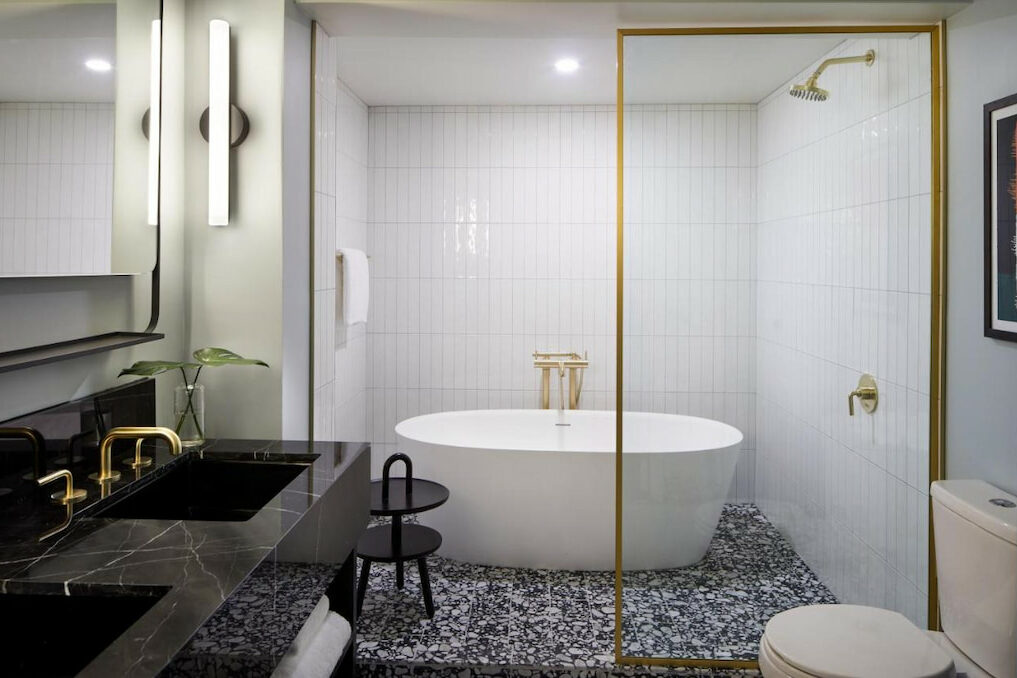 View of the luxury hotel's bathroom with wide space and a modern tub