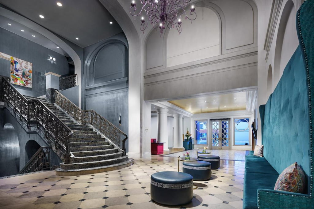 View of the staircase with royalty-feel in the lobby area with high ceilings