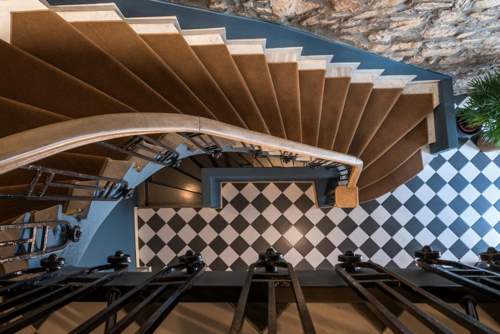 View of the stairs and checkered-style flooring on one of the villa rentals in Athens Greece