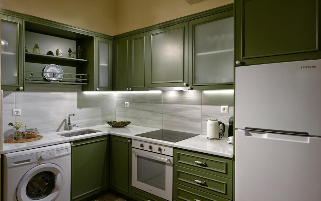View of the kitchen with green cabinets and drawers with full facilities