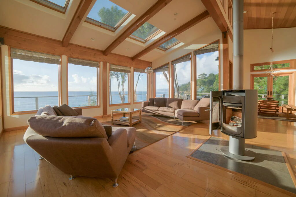 A luxurious cabin with multiple windows and a spacious living room